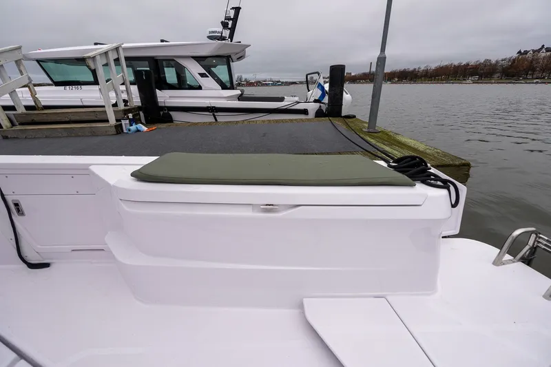 Slide: The Image of 2027 Axopar 38 Cross Cabin docked by the water on a cloudy day. - 16