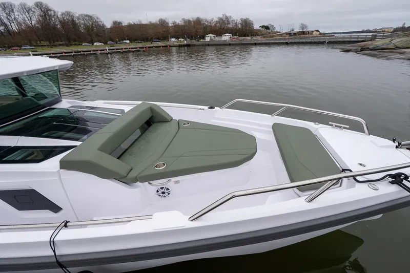 Slide: The Image of 2027 Axopar 38 Cross Cabin boat with sleek seating on calm water. - 3