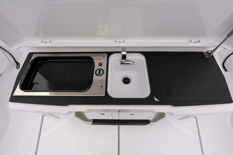 Slide: The Image of 2027 Axopar 38 Cross Cabin kitchenette with sink and stove. - 8