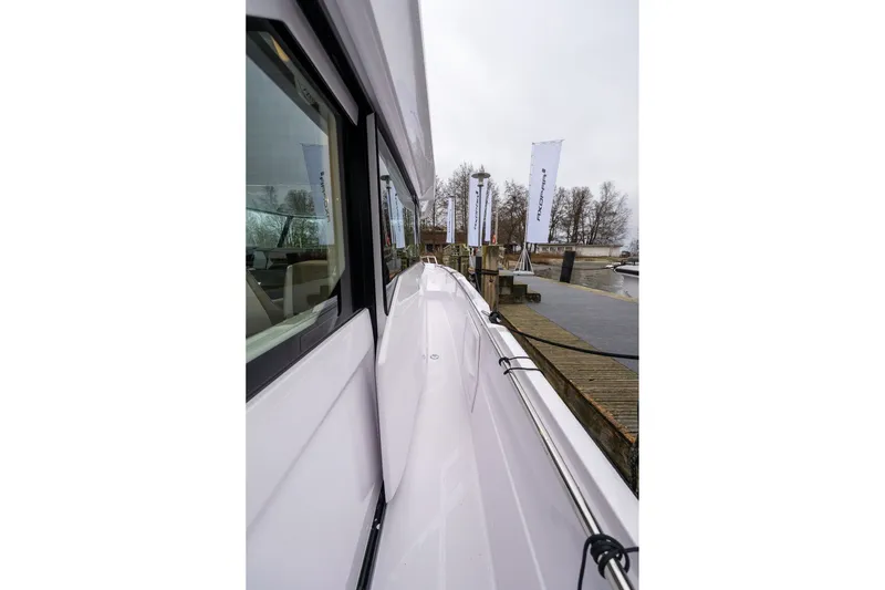 Slide: The Image of Side view of 2027 Axopar 38 Cross Cabin docked at a marina. - 18