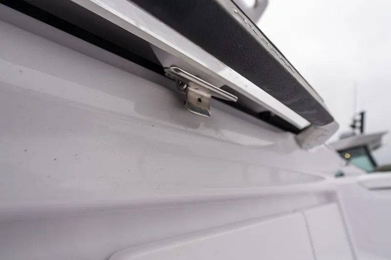 Slide: The Image of Close-up of a 2027 Axopar 38 Cross Cabin boat detail, showcasing a metal latch. - 10