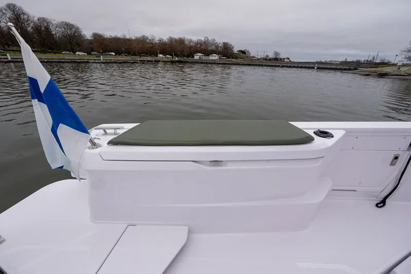 Slide: The Image of 2027 Axopar 38 Cross Cabin boat with Finnish flag on calm water. - 14