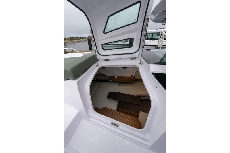 Slide: The Image of Interior view of 2027 Axopar 38 Cross Cabin, showcasing seating and wooden flooring. - 21