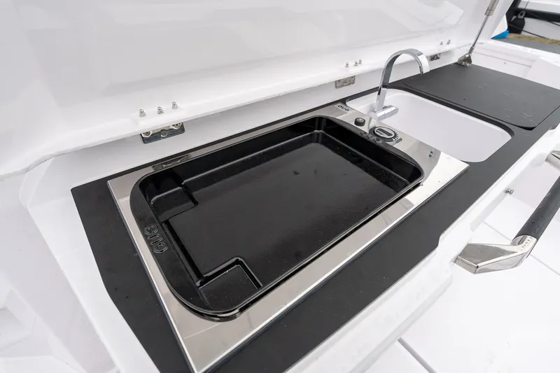 Slide: The Image of 2027 Axopar 38 Cross Cabin kitchen area with sleek sink and modern design. - 9