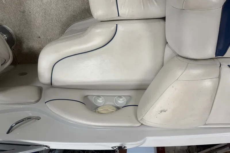 Slide: The Image of 2005 Crownline 226 LS boat interior with white leather seating and cup holders. - 18