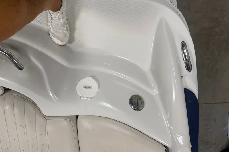 Slide: The Image of 2005 Crownline 226 LS boat interior with white upholstery and deck details. - 25
