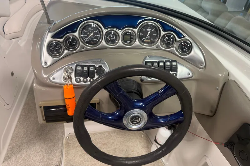 Slide: The Image of Dashboard of a 2005 Crownline 226 LS boat with gauges and steering wheel. - 22