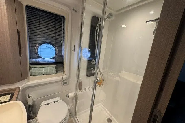 Slide: The Image of Luxurious bathroom in 2023 Azimut Fly 50 yacht with modern shower and porthole window. - 37