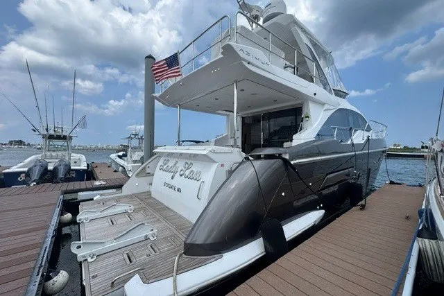 Slide: The Image of 2023 Azimut Fly 50 yacht docked, featuring sleek design and American flag. - 4