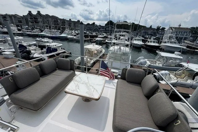 Slide: The Image of Luxurious 2023 Azimut Fly 50 yacht with elegant seating, docked in a bustling marina. - 38
