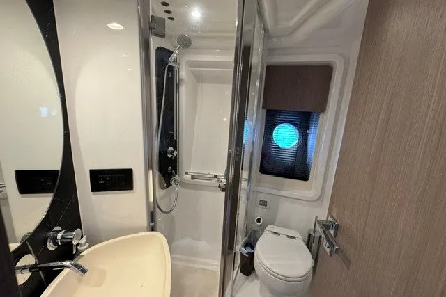 Slide: The Image of Luxurious bathroom in 2023 Azimut Fly 50 yacht with modern fixtures and porthole window. - 28