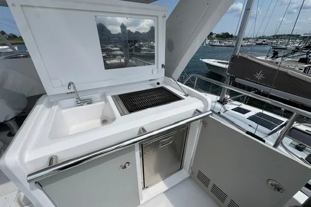 Slide: The Image of Outdoor kitchen on 2023 Azimut Fly 50 yacht with sink and grill, docked at marina. - 39