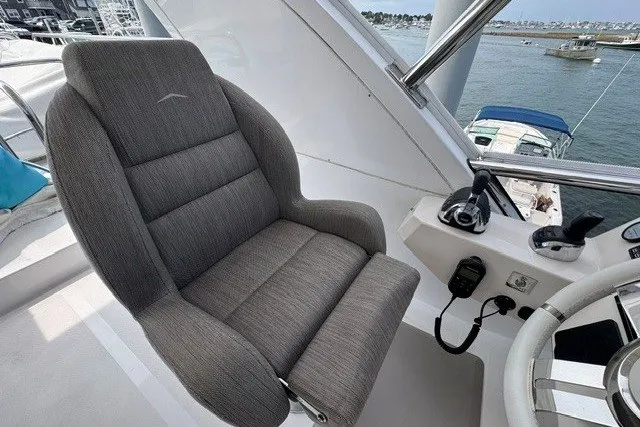 Slide: The Image of Captain's chair on 2023 Azimut Fly 50 yacht, overlooking marina. - 41