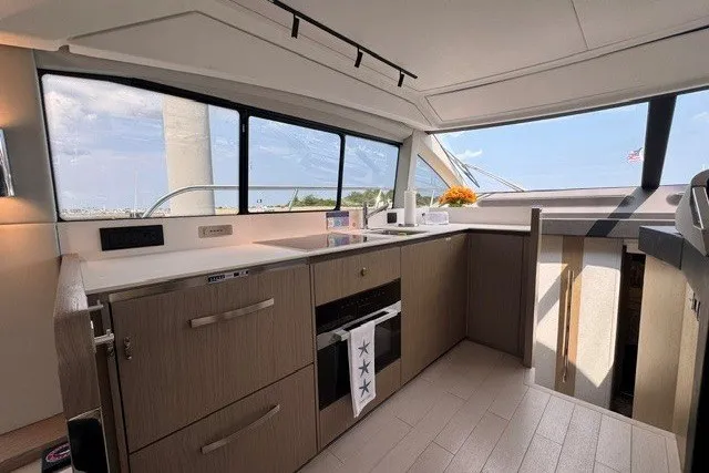 Slide: The Image of Modern kitchen interior of 2023 Azimut Fly 50 yacht with sleek cabinetry and large windows. - 16