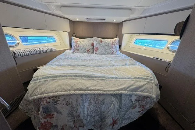 Slide: The Image of Luxurious bedroom interior of 2023 Azimut Fly 50 yacht with elegant bedding and side windows. - 26