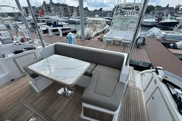 Slide: The Image of Luxurious 2023 Azimut Fly 50 yacht with elegant seating and marina view. - 8