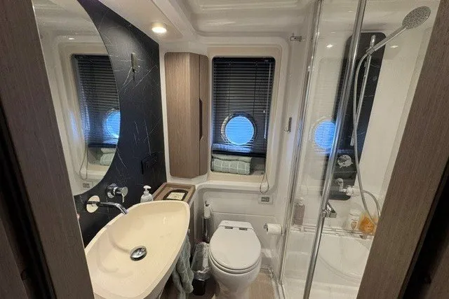 Slide: The Image of Luxurious bathroom in 2023 Azimut Fly 50 yacht with modern fixtures and porthole window. - 36