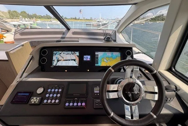 Slide: The Image of 2023 Azimut Fly 50 yacht cockpit with navigation screens and steering wheel. - 20