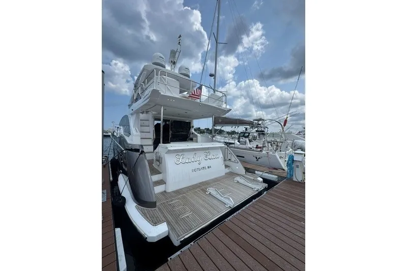 Slide: The Image of Azimut Fly 50 yacht docked, 2023 model, with cloudy sky background. - 6