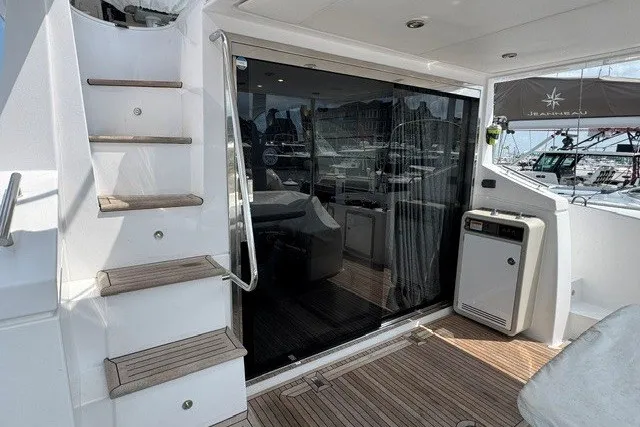 Slide: The Image of 2023 Azimut Fly 50 yacht deck with stairs and sliding glass door. - 10