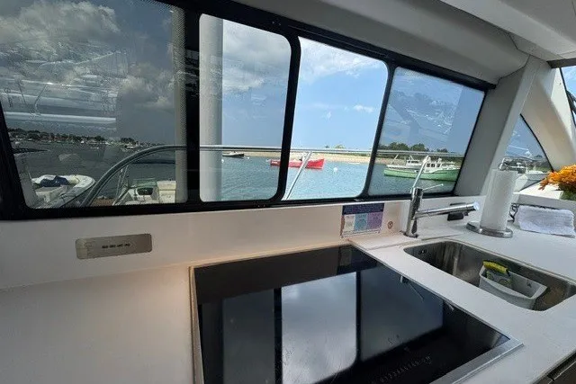 Slide: The Image of Interior view of 2023 Azimut Fly 50 yacht kitchen with sea view through windows. - 18