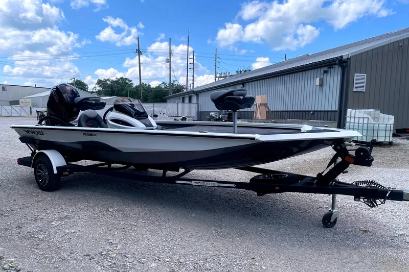 Slide: The Image of A 2023 Vexus AVX189C boat on a trailer, parked on gravel in front of a building. - 6