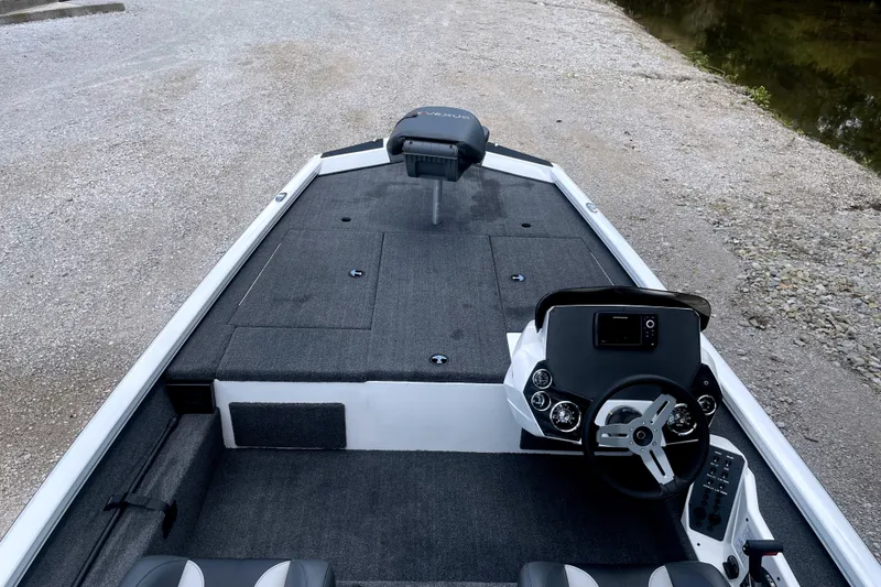 Slide: The Image of The image shows the cockpit of a 2023 Vexus AVX189C boat with gray carpeting. - 7