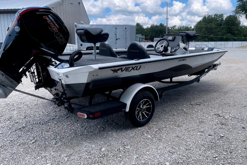 Slide: The Image of A 2023 Vexus AVX189C boat on a trailer, featuring an outboard motor and two seats. - 5