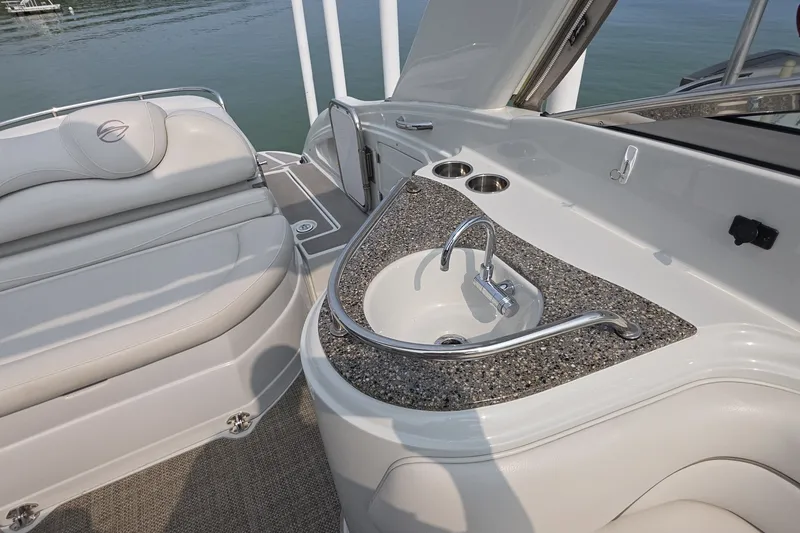Slide: The Image of Luxurious 2017 Crownline 325 SCR boat interior with sink and seating area. - 7