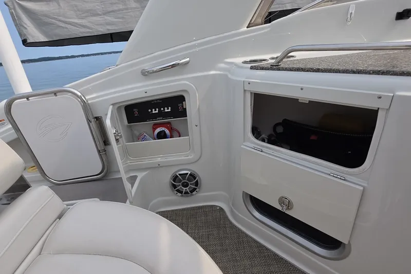 Slide: The Image of Interior view of a 2017 Crownline 325 SCR boat with storage compartments. - 10