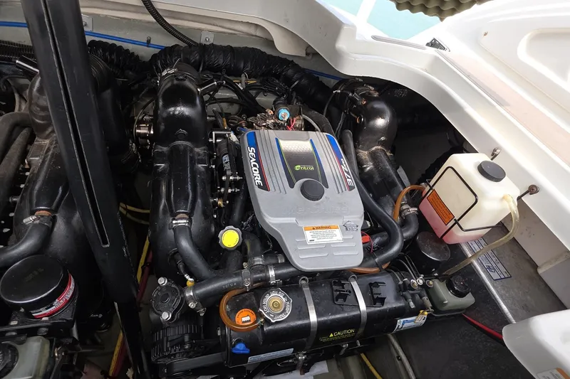 Slide: The Image of Engine compartment of a 2017 Crownline 325 SCR boat, featuring a Seacore engine. - 43