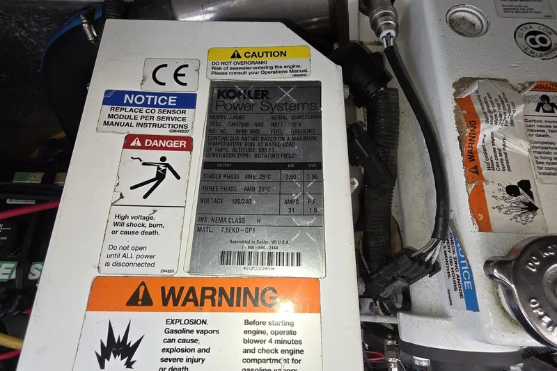 Slide: The Image of Engine compartment of a 2017 Crownline 325 SCR with Kohler power system warnings. - 41