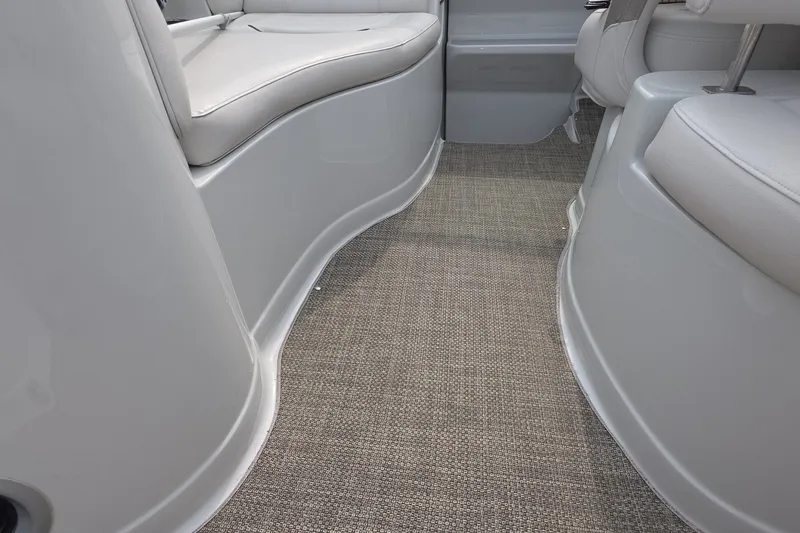 Slide: The Image of 2017 Crownline 325 SCR interior with beige carpet and white seating. - 20