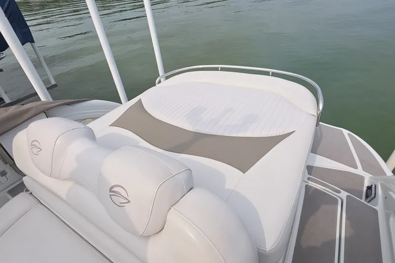 Slide: The Image of 2017 Crownline 325 SCR boat with white cushioned seating on deck. - 12