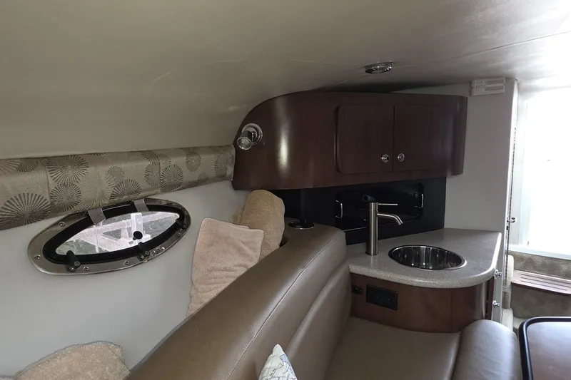 Slide: The Image of Interior of 2017 Crownline 325 SCR boat with kitchenette and seating area. - 37