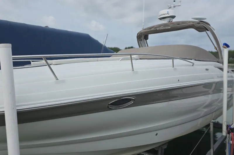 Slide: The Image of 2017 Crownline 325 SCR boat docked, featuring sleek design and modern equipment. - 5