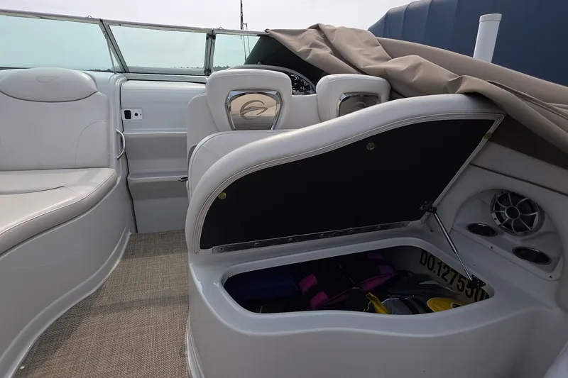 Slide: The Image of 2017 Crownline 325 SCR boat interior with open storage compartment and seating. - 21