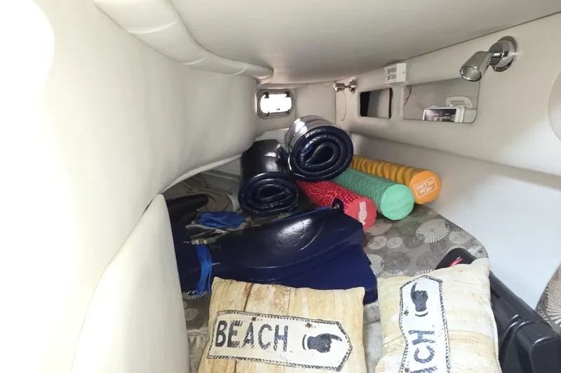 Slide: The Image of Interior cabin of 2017 Crownline 325 SCR with beach-themed pillows and rolled mats. - 32