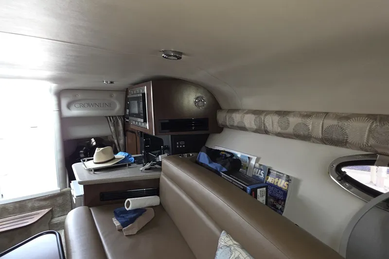 Slide: The Image of Interior of 2017 Crownline 325 SCR boat with seating, kitchenette, and decor. - 36