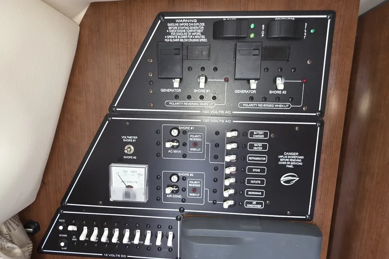Slide: The Image of Electrical control panel of a 2017 Crownline 325 SCR boat, featuring switches and voltmeter. - 39