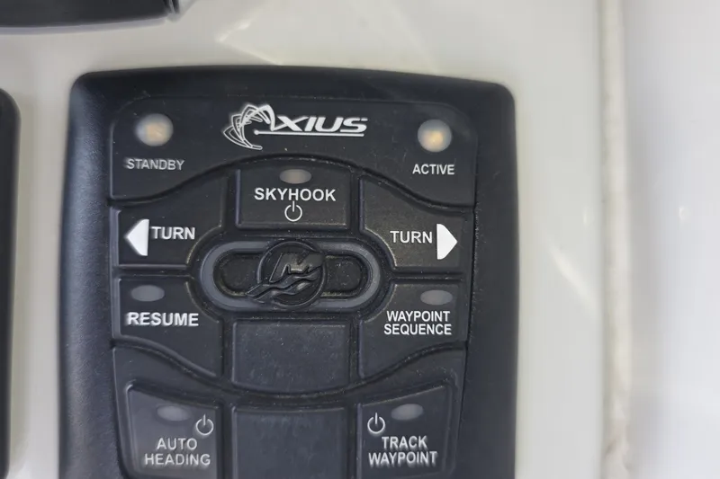 Slide: The Image of Control panel of a 2017 Crownline 325 SCR boat featuring Axius system buttons. - 19