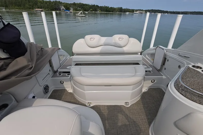 Slide: The Image of 2017 Crownline 325 SCR boat interior with seating, lake view, and modern design. - 8