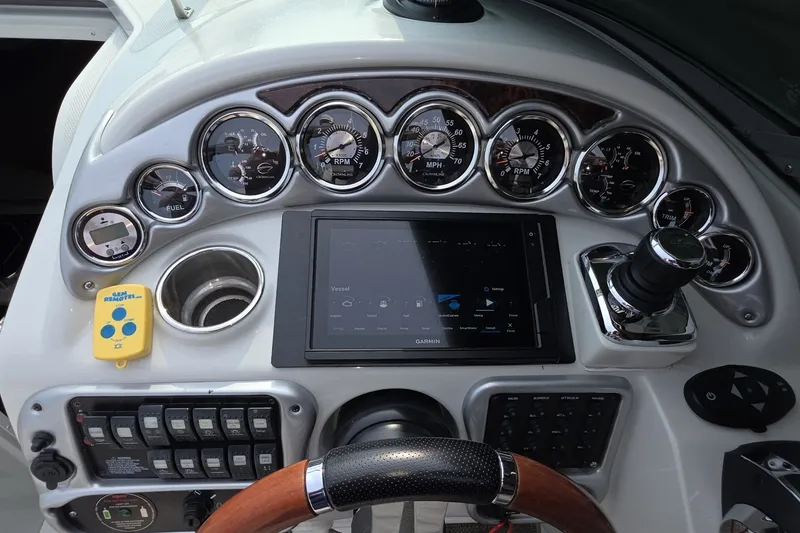 Slide: The Image of Dashboard of 2017 Crownline 325 SCR boat with gauges and Garmin display. - 14