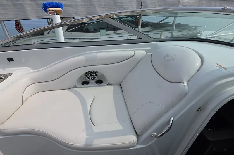 Slide: The Image of Luxurious seating on a 2017 Crownline 325 SCR boat, featuring white upholstery and sleek design. - 28