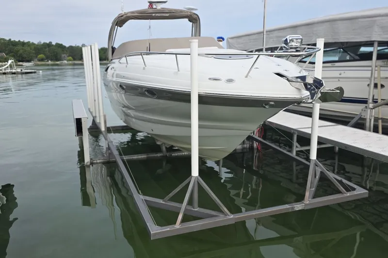 Slide: The Image of 2017 Crownline 325 SCR boat on lift at marina dock. - 4
