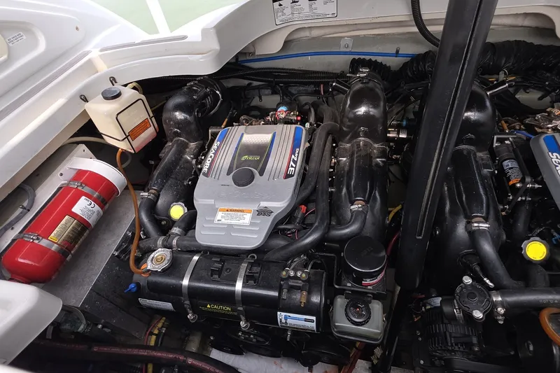Slide: The Image of Engine compartment of a 2017 Crownline 325 SCR boat, featuring dual engines and safety equipment. - 42