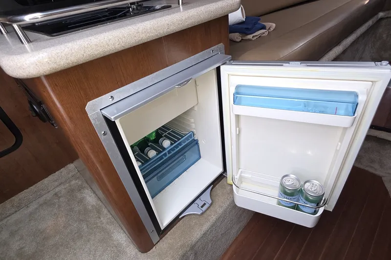 Slide: The Image of Compact fridge in 2017 Crownline 325 SCR boat interior, stocked with beverages. - 30