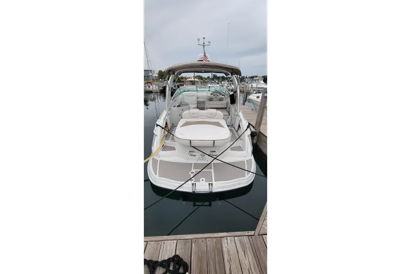 Slide: The Image of 2017 Crownline 325 SCR boat docked at marina, rear view. - 3