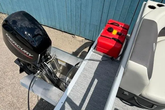 Slide: The Image of 2026 Sun Tracker Bass Buggy 16 XL Select with Mercury outboard motor and red fuel tank. - 14