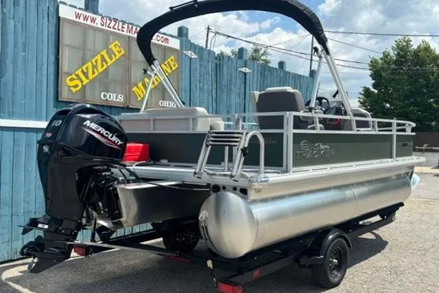 Slide: The Image of 2026 Sun Tracker Bass Buggy 16 XL Select pontoon boat with Mercury engine on trailer. - 3
